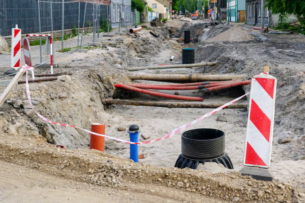 istock Street reconstruction view with deep trench, old and replaced underground pipes, new plastic well 1646868122