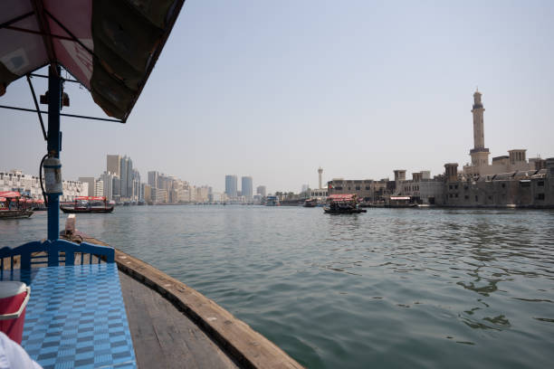 Captured from a small boat on the Dubai River, this photograph offers a unique perspective of the juxtaposition between old and new Dubai. The waters gently reflect the city's dual identity as towering modern skyscrapers of 'New Dubai' stand tall on one side, while the historic architecture of 'Old Dubai' graces the other. The tranquil river becomes a bridge between eras, connecting the bustling energy of the present with the echoes of the past. This image encapsulates the evolving spirit of Dubai, where tradition and progress harmoniously coexist along the banks of time.