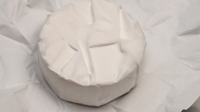 Camembert cheese round, rotation in circle. Camembert grilled cheese, Turning.