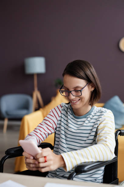 istock Girl with disability using smartphone at home browsing social media 1646912216