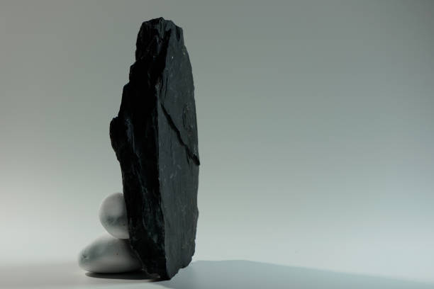 istock white smooth stones behind one big black 1646912766