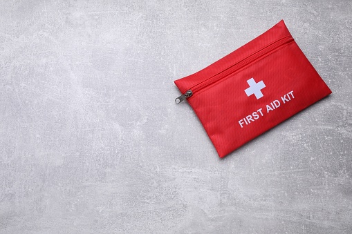 Medicine bag on light gray background, top view with space for text. First aid kit