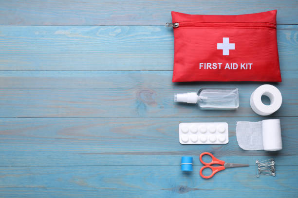 istock Flat lay composition with first aid kit on blue wooden table, space for text 1646923479