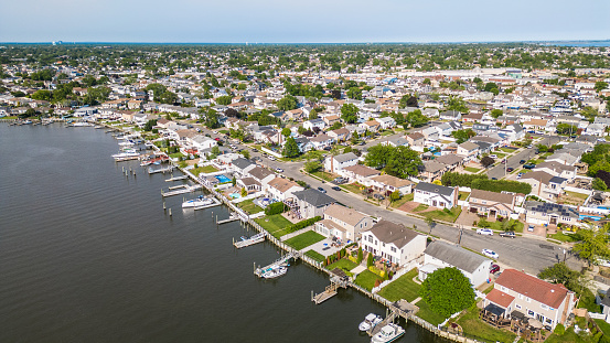 Aerial overhead view of typical suburban Long Island New York community with homes, boats and water.