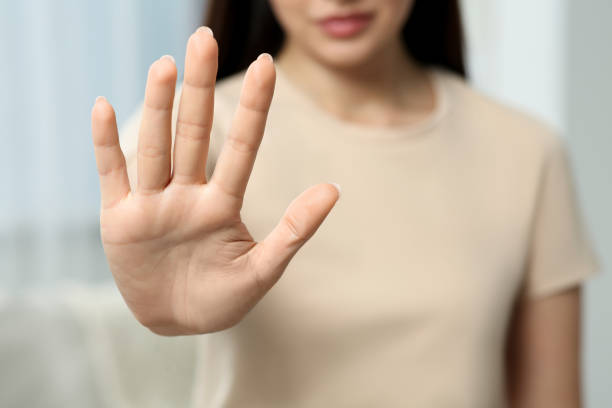 istock Woman showing stop gesture indoors, selective focus 1646945871