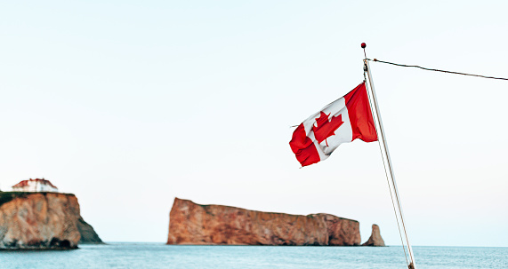 Saskatchewan and Canada flags against blue sky. Regina, Saskatchewan, Canada.