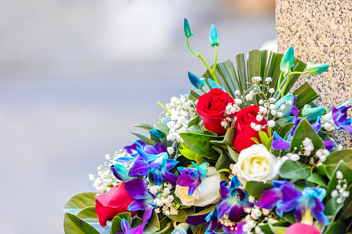 Closeup wreath on tombstone, background with copy space, full frame horizontal composition