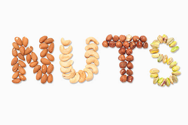 istock nuts spelled with almonds, cashews, filberts, and pistachios 164696452