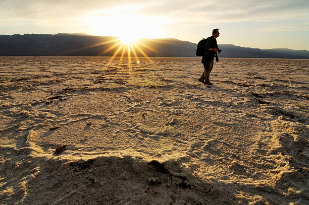 istock Back litted landscape with backpacker in Badwater, Death Valley, California 164696646