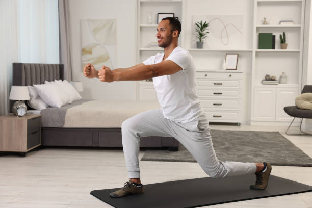 istock Man doing morning exercise on fitness mat at home 1646970015