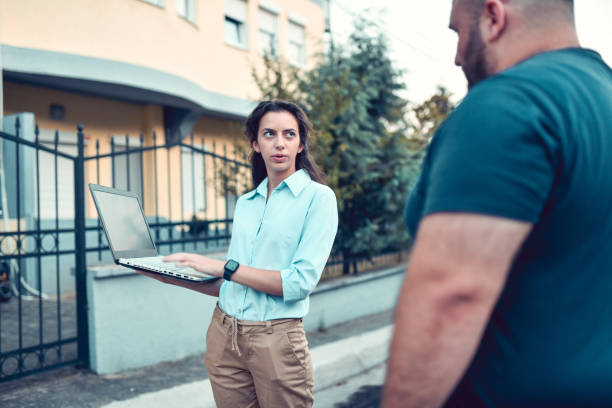 Building Owner Documenting Building Damage With Insurance Agent