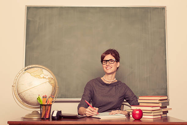 Vintage Classroom Portrait of a retro elementary school teacher ready to teach a lesson. uncool stock pictures, royalty-free photos & images