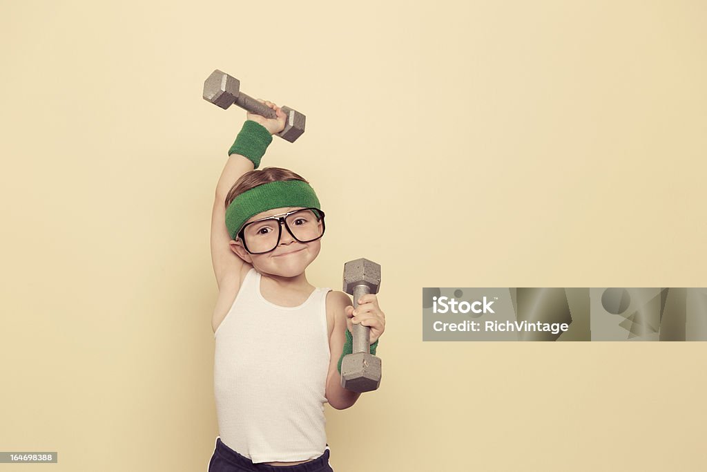 Heavy Lifter A young nerd is ready to build some muscle. Child Stock Photo