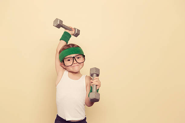 Heavy Lifter A young nerd is ready to build some muscle. muscular build photos stock pictures, royalty-free photos & images