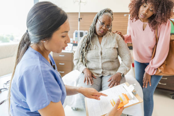istock Nurse holds pill bottle while discussing test results with woman 1646996251