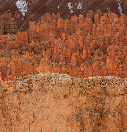 Near sunset, the statuesque hoodoos of Bryce Canyon take on an orange glow as light reflecting off the canyon walls illuminates the shaded sides of the pillars.  Hoodoos are formed by a natural process called frost-wedging.  When snow and ice melt, water seeps into cracks in the rocks.  Later, when the water re-freezes, it expands the cracks.  This occurs with exceptional frequency at Bryce Canyon, which has led to the park’s stunning array of these spire-shaped formations.