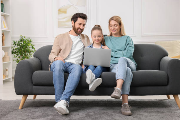 Free Stock Photo of Three People Sitting on a Couch Looking at a Laptop ...