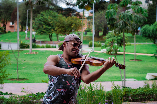 street artist playing a fiddle in colombia