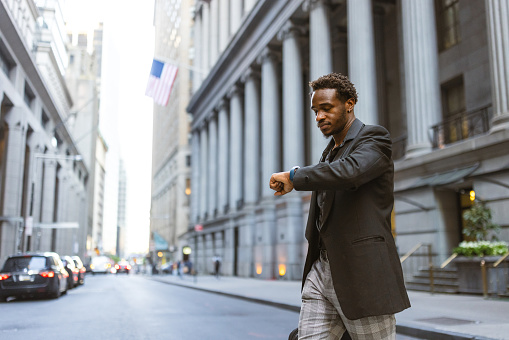 African-American Businessman rushing to the office in Wall Street