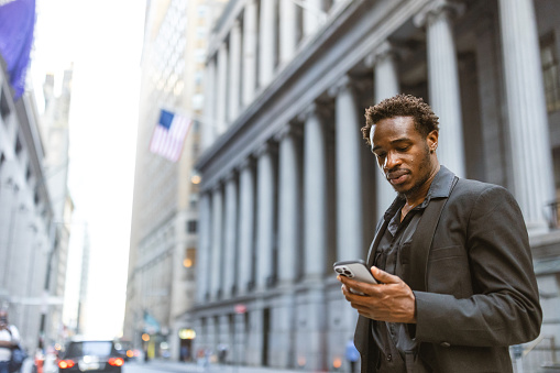 African-American Businessman rushing to the office in Wall Street