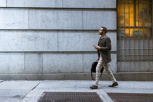 African-American Businessman rushing to the office in Wall Street area