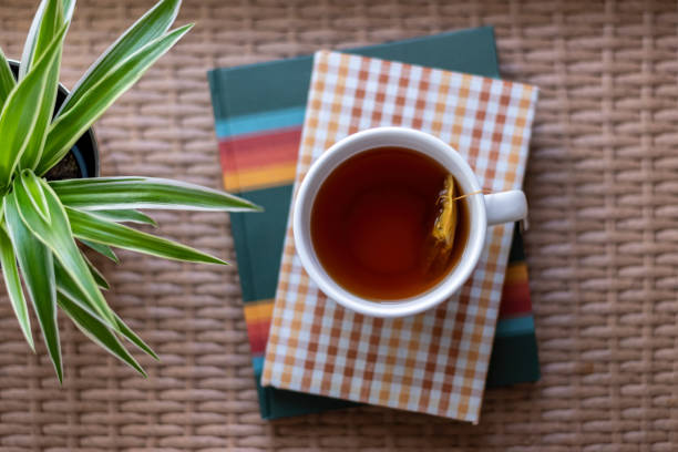 Top view of a cup of hot tea and books