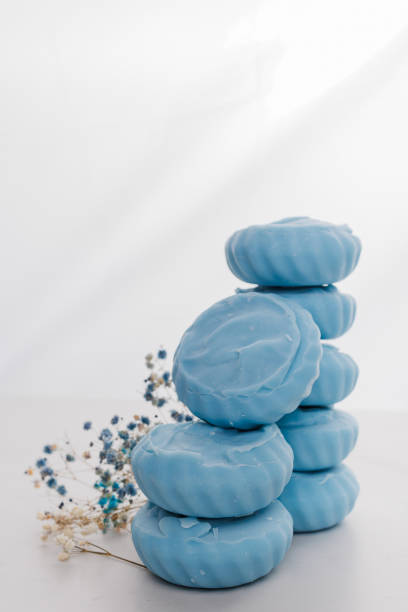 istock Handmade light blue soap with flowers on fabric, close-up. 1647086318