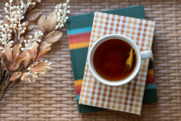 Selective focus closeup of hot tea and books