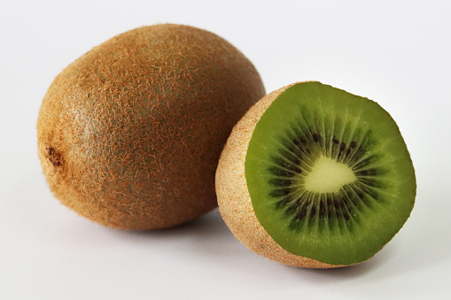 Stock photo showing a close-up view of healthy eating image of a group of one and a half Chinese gooseberry (kiwi).