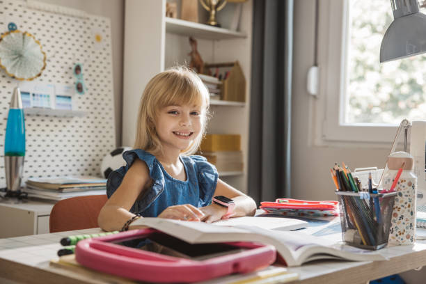 istock Schoolgirl studying at home 1647107518