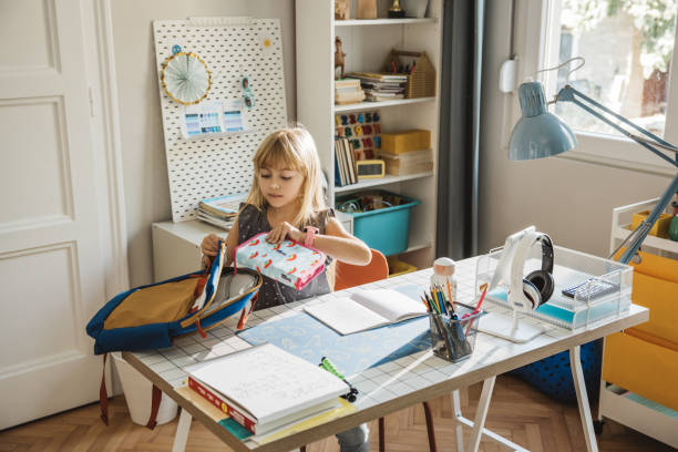 istock Schoolgirl packing for school 1647108561