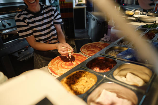 istock Young Woman Working at Pizzeria Restaurant 1647119577