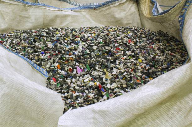 istock Shredded plastic pieces prepare for recycling. Raw cables material for reproduction. Sorting garbage on waste plant. Pile of scrap bottles on trash storage factory. Environmental concept 1647137915