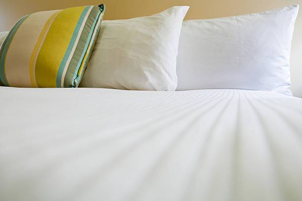 istock Stripy cushion and two pillows on a double bed 164713915