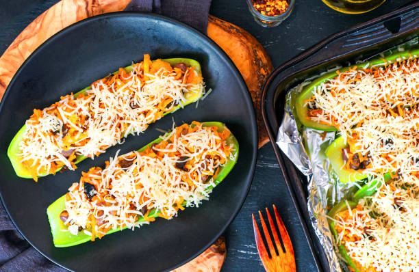 istock Stuffed zucchini with vegetables and cheese on a plate, top view 1647176005