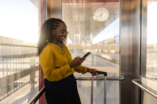 istock A young African American woman using phone while standing in an elevator 1647177063