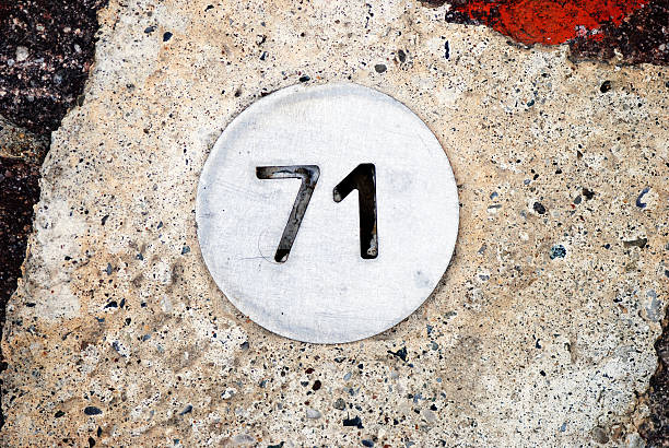 istock Number 71 on circular metal plate 164718609