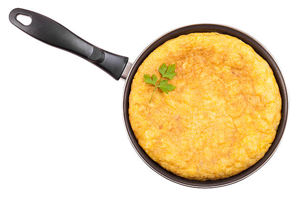 Spanish potato omelette in the frying pan Isolated with clipping path. By far the most popular Spanish tapa tortilla de patatas stock pictures, royalty-free photos & images