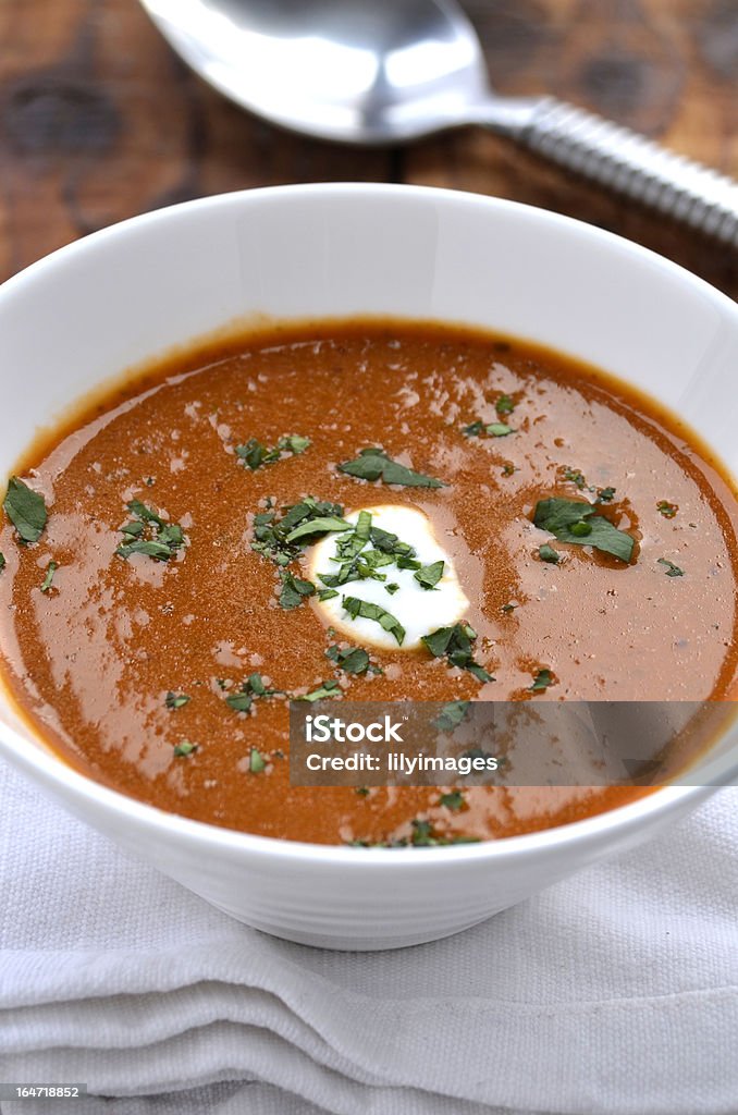 Spicy tomato soup spicy tomato soup in a white bowl with a wooden background Tomato Stock Photo