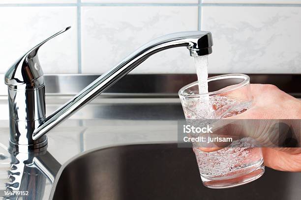 Glass Filled With Drinking Water From Kitchen Faucet Stock Photo - Download Image Now