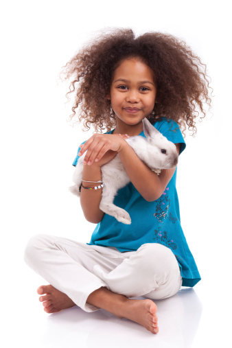 African Asian girl holding a rabbit, isolated on white background