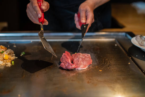 istock Chef cooking in Japanese teppanyaki restaurant 1647197117