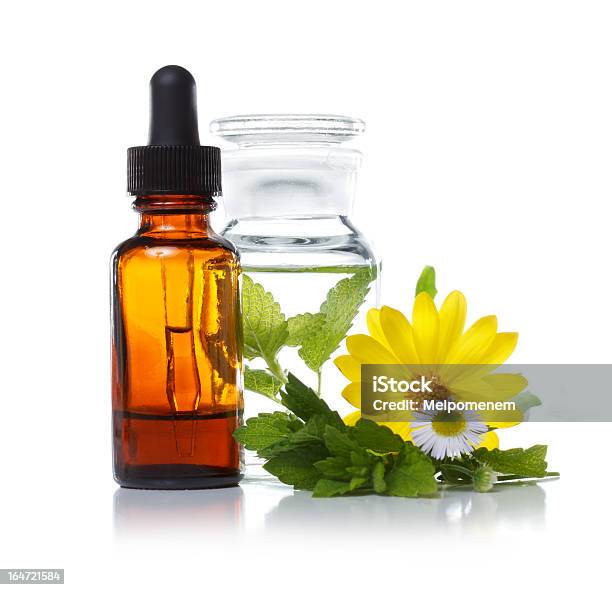 Dropper Bottle Sitting With Herbs And A Flower Stock Photo - Download Image Now - Homeopathic Medicine, Herb, Herbal Medicine