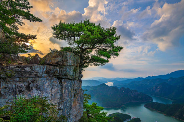 istock Yellowish blue sky, beautiful clouds, cliffs, trees, rivers and mountains. 1647216888