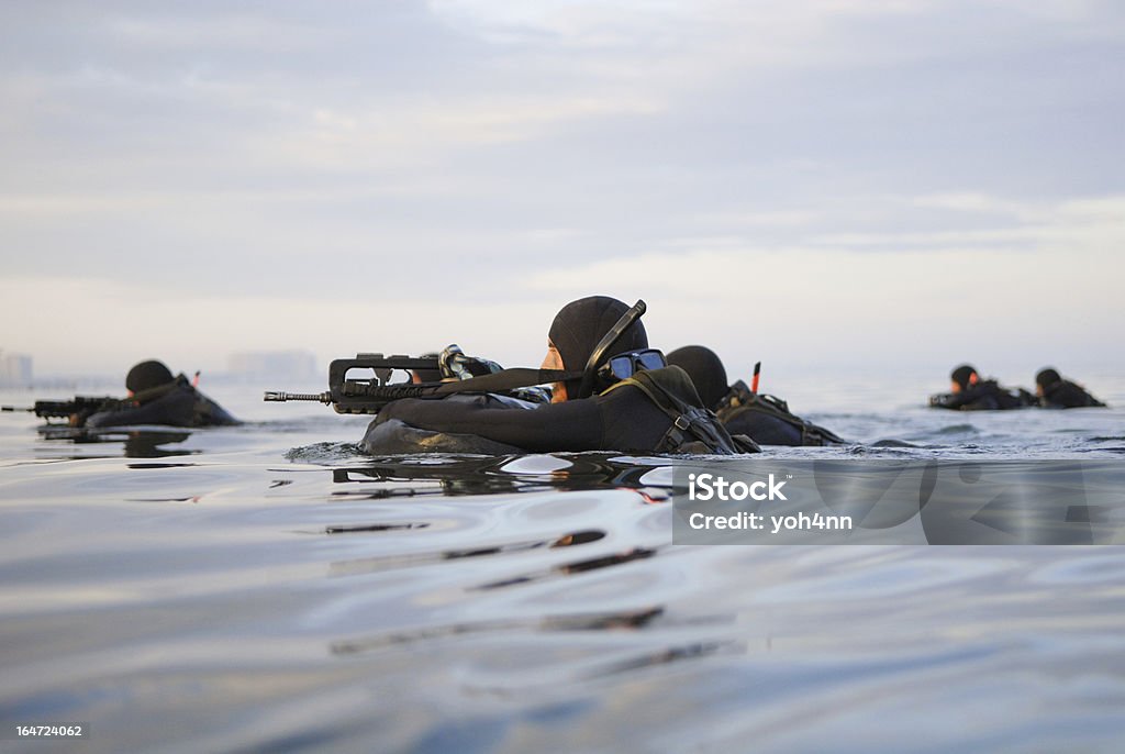Soldats avec des fusils nager dans la mer - Photo de United States Navy SEALs libre de droits