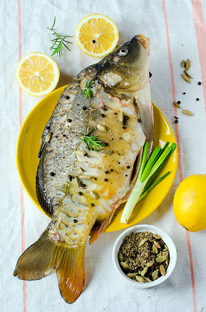 Fresh carp Fresh carp with lemon Cardamom stock pictures, royalty-free photos & images