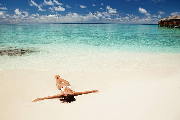istock Cute woman relaxing on the tropical beach 164724692