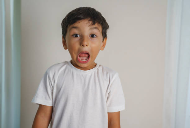 Portrait of boy sticking out tongue