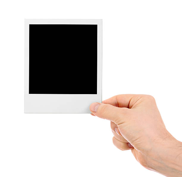 istock Hand holding instant shot frame isolated 164727693