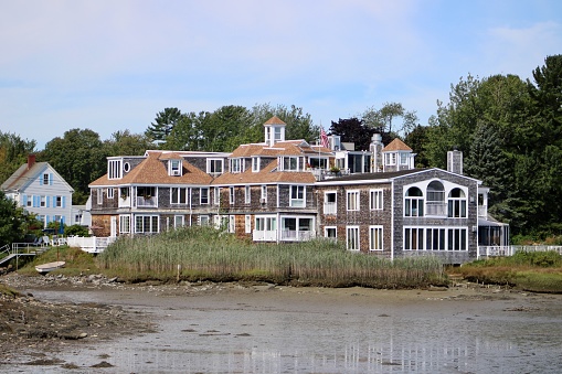 Kennebunkport, ME, USA, 9.3.22 - The front exterior of the Boatyard Condominium complex across the river during low tide.